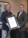 NOVEC President/CEO Stan Feuerberg (left) receives a copy of House Joint Resolution No. 399 from Delegate David Poisson.