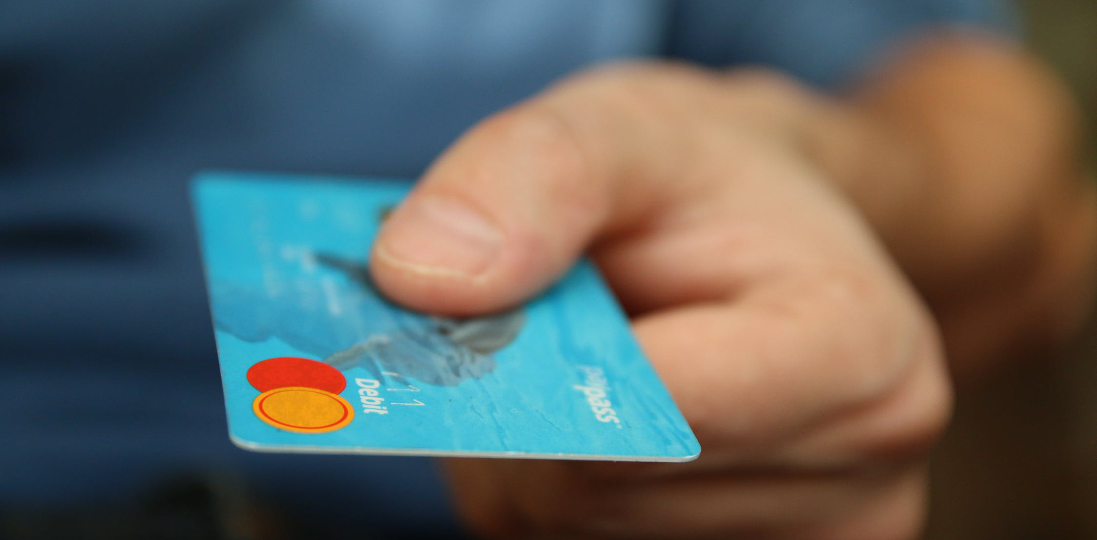 Hand holding debit card Hand holding debit card