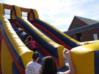 Children climb the inflatable slide.