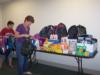 Pat Wilcox and Ann Phares stuff backpacks for homeless children.